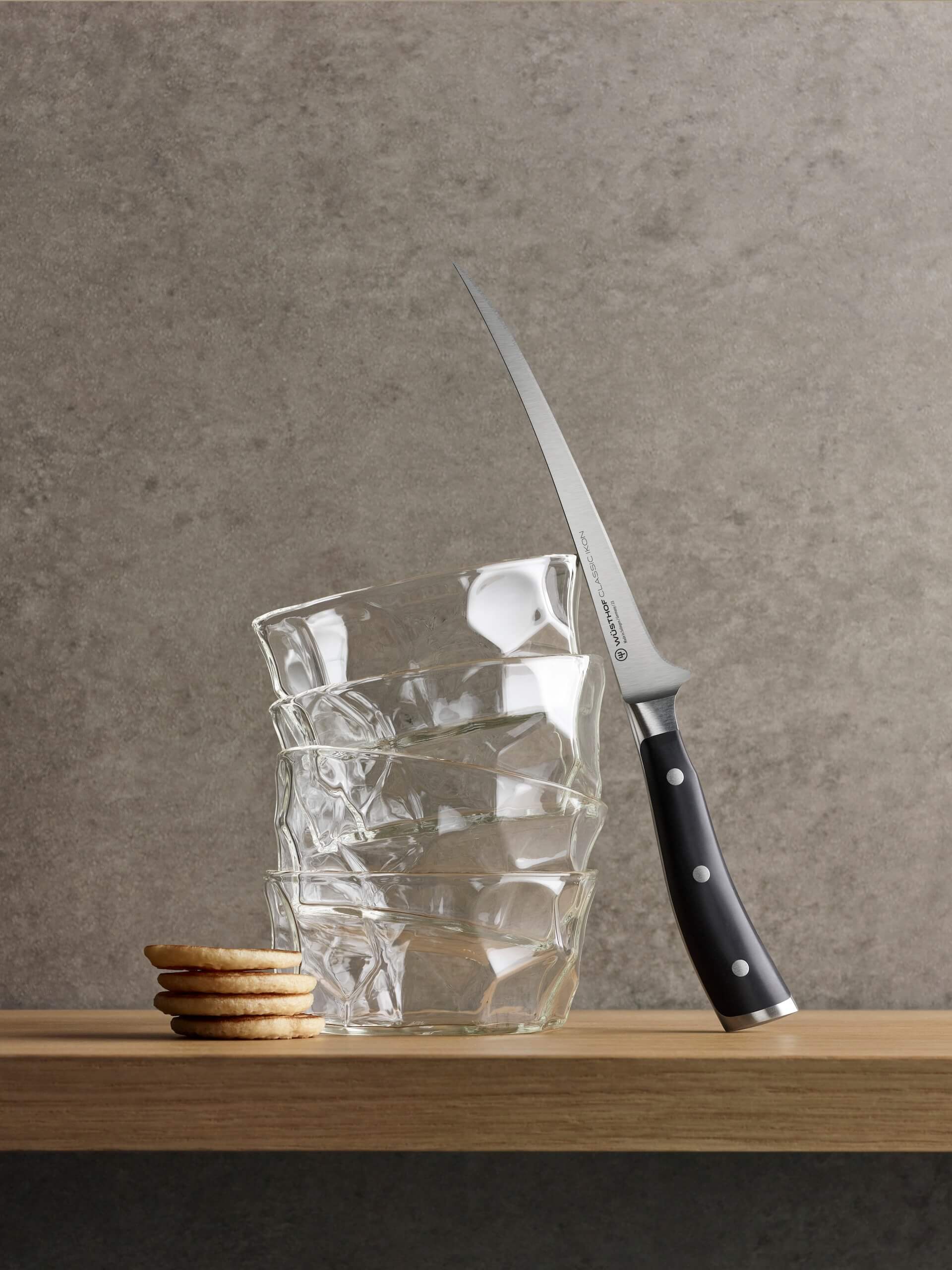 classic ikon fillet knife leaning against glasses