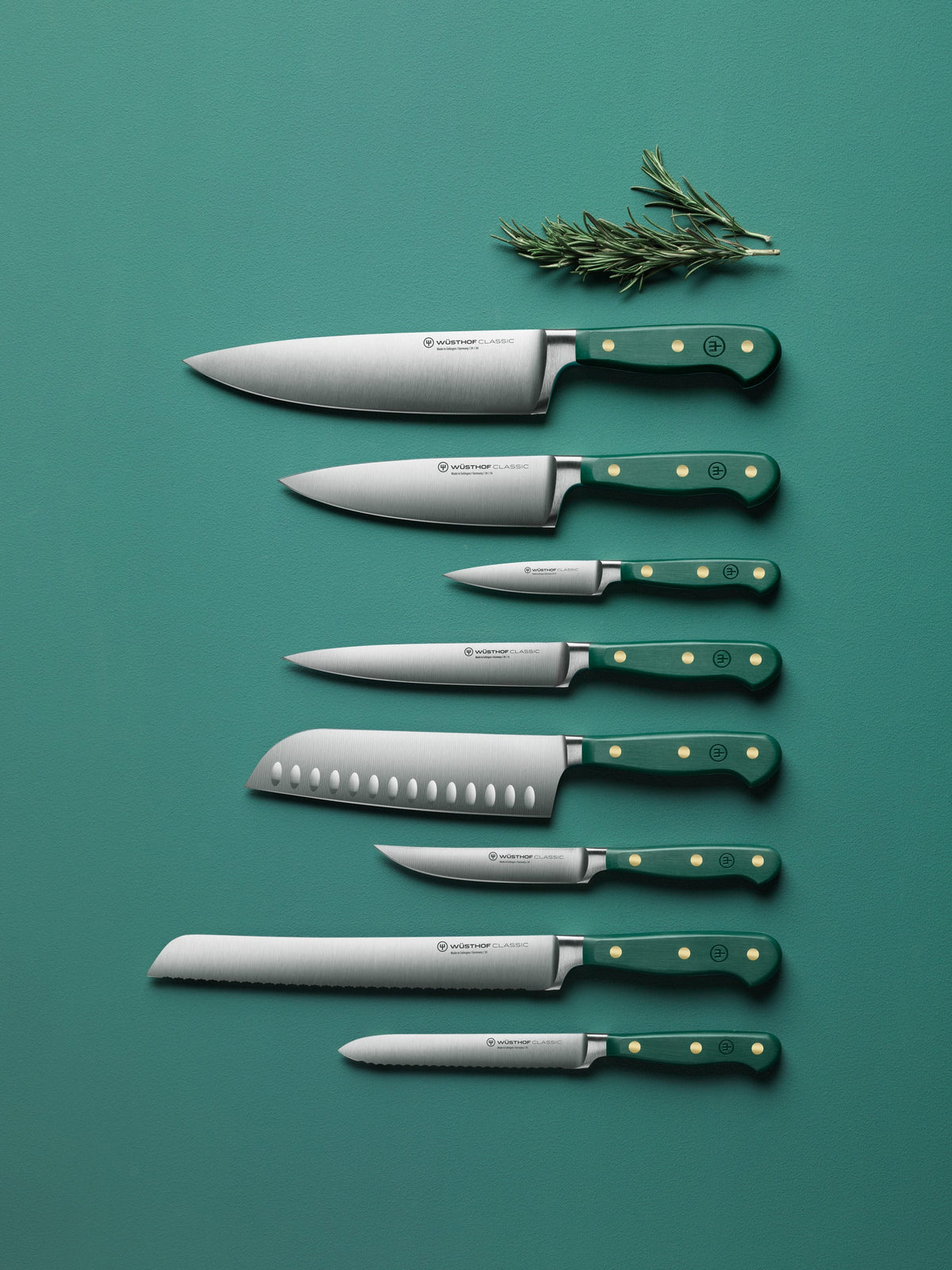 Set of knives with green handles on a teal background